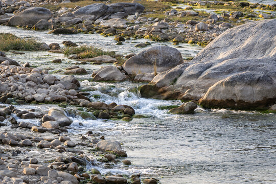 mountain river water flowing at evening from flat angle