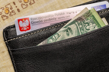 Polish New ID card and 100 PLN banknote, identity document, money for current expenses, black wallet, Poland finances and official matters - 772232180
