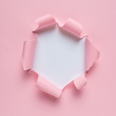 Vivid pink ripped paper with burst hole background. Minimal abst