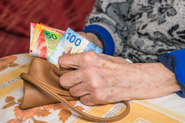 A pensioner in Switzerland counts money, Swiss francs - problems of older people, financial concept