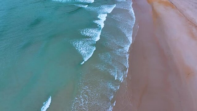 Waves and designs on the beach of Lua&ntilde;a or C&oacute;breces. Aerial view from a drone. Alfoz de Loredo Municipality. Cantabrian Sea. Cantabria. Spain. Europe