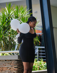 A portrait of a young African lady holding a balloon 