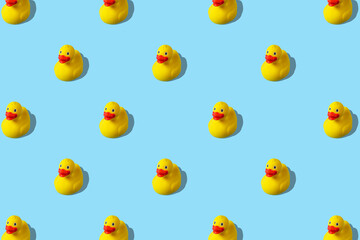 Trendy summer pattern with yellow rubber duck on bright blue background. Minimal summer concept.