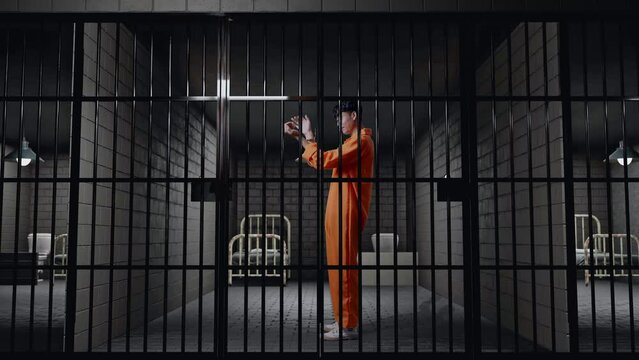 Full Body Side View Of Asian Male Prisoner With Broken Handcuffs Screaming Goal Celebrating While Standing In Prison