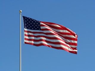 A large American flag is flying in the sky. The flag is red, white, and blue