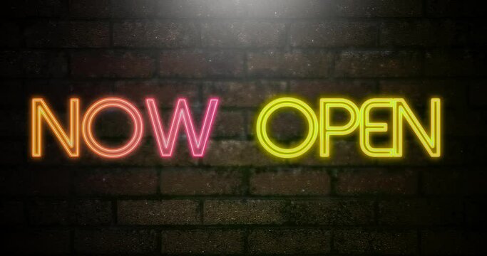 "Now open" text  slogan flashing in the neon light on the background of a brick wall