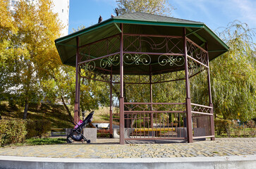 Rest area with bench in Kyiv, Europe. Place to rest in the city park. Rotunda or gazebo on the river embankment