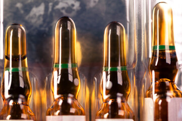 A group of unused glass injection ampoules. Brown ampoules with medicines