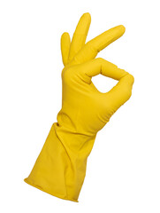 A hand in yellow rubber gloves shows a thumbs up on a white background. Rubber gloves isolate