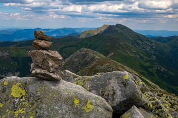 Small stack of stones against the background of majestic mountains in Low Tatras National Park.