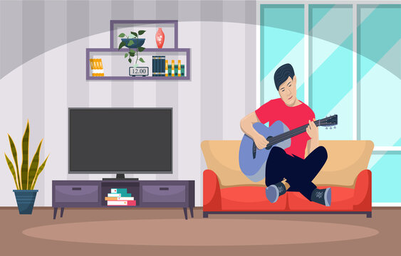 A man happily plays a guitar on a sofa in the living room.