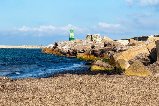 Picturesque lighthouse near a beach in Bizerte, Tunisia, illuminated by the golden rays of the sun