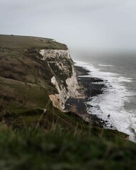 Coastal landscape with a white-chalked beach surrounded by steep cliffs, the White Cliffs of Dover