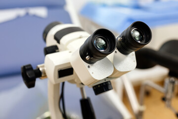 Close-up of a gynecological office with a colposcope near a gynecological chair in a modern hospital. Concept of pregnancy, modern medicine and medical technology.