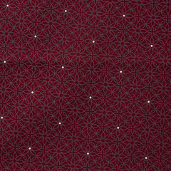 Close up detail of burgundy fabric texture background with tiny dot pattern