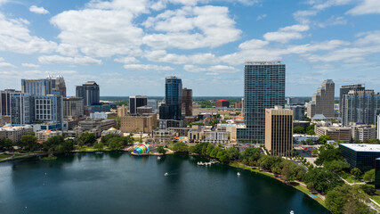 Downtown Orlando skyline overlooking the tranquil Lake Eola Park with its iconic fountain and urban backdrop.