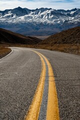 Empty road with a vast mountain range in the background, Eastern Sierra - obrazy, fototapety, plakaty