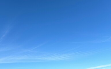 Empty blue sky with wispy cirrus clouds