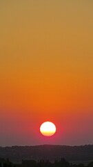 Stunning view of a setting sun over a rural landscape.