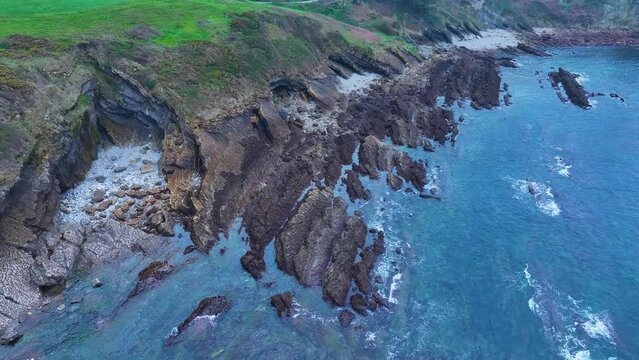 Rock formations and coastal landscape around the town of Comillas. Aerial view from a drone. Comillas Municipality. Cantabrian Sea. Cantabria. Spain. Europe