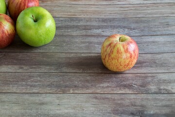 Fresh red and green apples on the wooden table