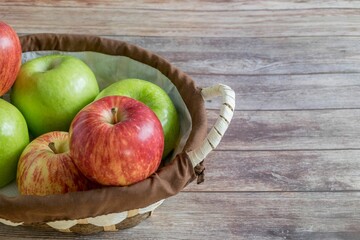 Basket overflowing with freshly-picked red and green apples