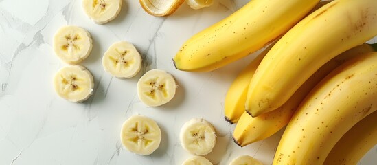A bunch of bananas placed on top of a table, showcasing their vibrant yellow color and appealing shape.