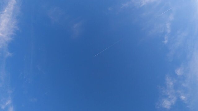 Low angle footage of the blue sky with cirrus uncinus clouds on a sunny day
