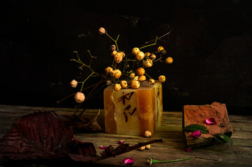 still life photography with avocado seeds, rose, fruits