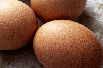 Close-up view of brown eggs with speckled surfaces, showcasing natural and organic food concepts.