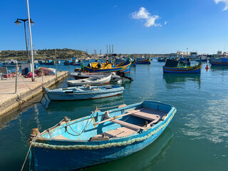 Naklejka na ściany i meble Fishing boats in the harbor of Marsaxlokk, Malta in a beautiful sunny day