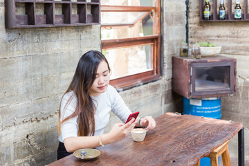 Beautiful business asian woman use smartphone business communication sitting in coffee shop - 772308373
