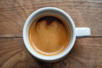 Focus on the swirls of cream and espresso in a doppio coffee shot, super realistic