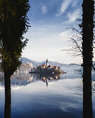 Scenic view of a lake Bled in Slovenia with a church visible through the trees in the background