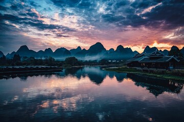 Picturesque landscape featuring a tranquil river at dusk, with majestic mountains and fluffy clouds