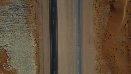 Closeup of the road in the middle of the desert in Saudi Arabia on a sunny day