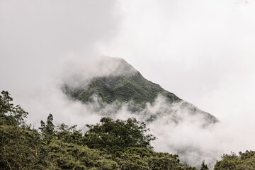 Scenic view of a mountain range covered with greenery on a cloudy day