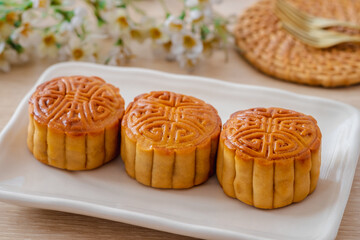 Obraz na płótnie Canvas Mooncake on white plate, Chinese mid autumn festival food