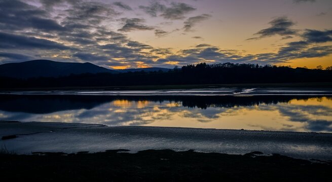 Idyllic landscape featuring a bright sunset sky over Nith Estuary near Solway Coast and Glencaple