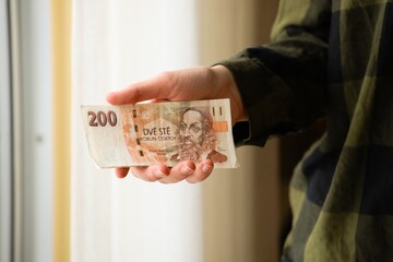 Czech crown bills in hands. Concept of money, banking, finance, savings