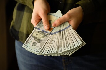American dollar bills in hands. Concept of money, banking, finance, savings