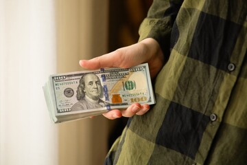 American dollar bills in hands. Concept of money, banking, finance, savings