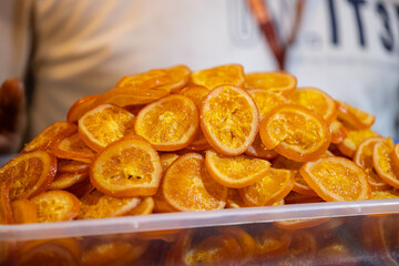 Colourful orange fruits for sale on display at trade fair.