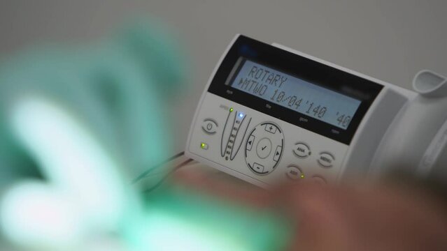 Electronic apex locator working during operation. Dentist's hands in gloves treating carefully teeth. Display of electronic device for the treatment of root canals in modern dental clinic. Close-up.