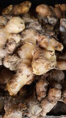 Close up pile of tasty fresh ginger sold at the market as a background.