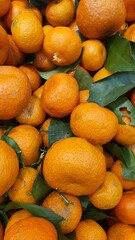 Close up pile of tasty fresh oranges sold at the market as a background.