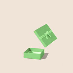 Green open gift box with on bright background. Minimal concept.