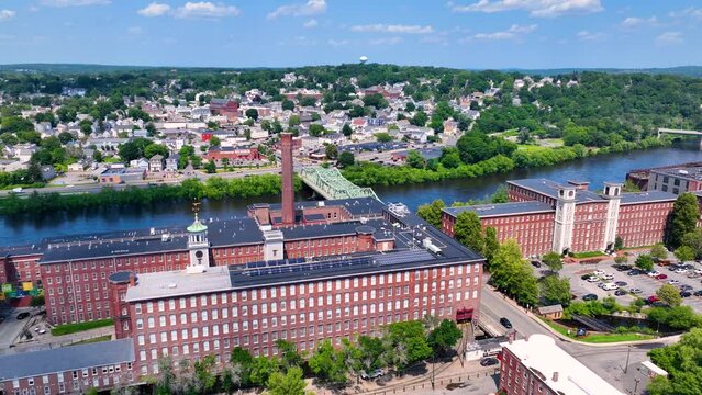 Boott Mills and John E. Cox Memorial Bridge over Merrimack River aerial view in Lowell National Historical Park in historic downtown Lowell, Massachusetts MA, USA. 