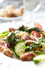 Healthy Salad with Chicken Breast, Cherry Tomatoes, Cucumber, Rocket and Green Olives. Close up.	