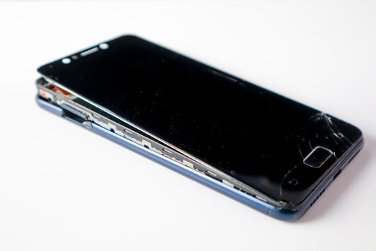 The cellphone body is split. Smartphone components are damaged